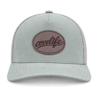 A sage green CLASSIC MESH  hat with a curved brim, featuring a light green front panel, a darker green mesh back, and a brown oval patch on the front with the brand name 'covelife' in script.