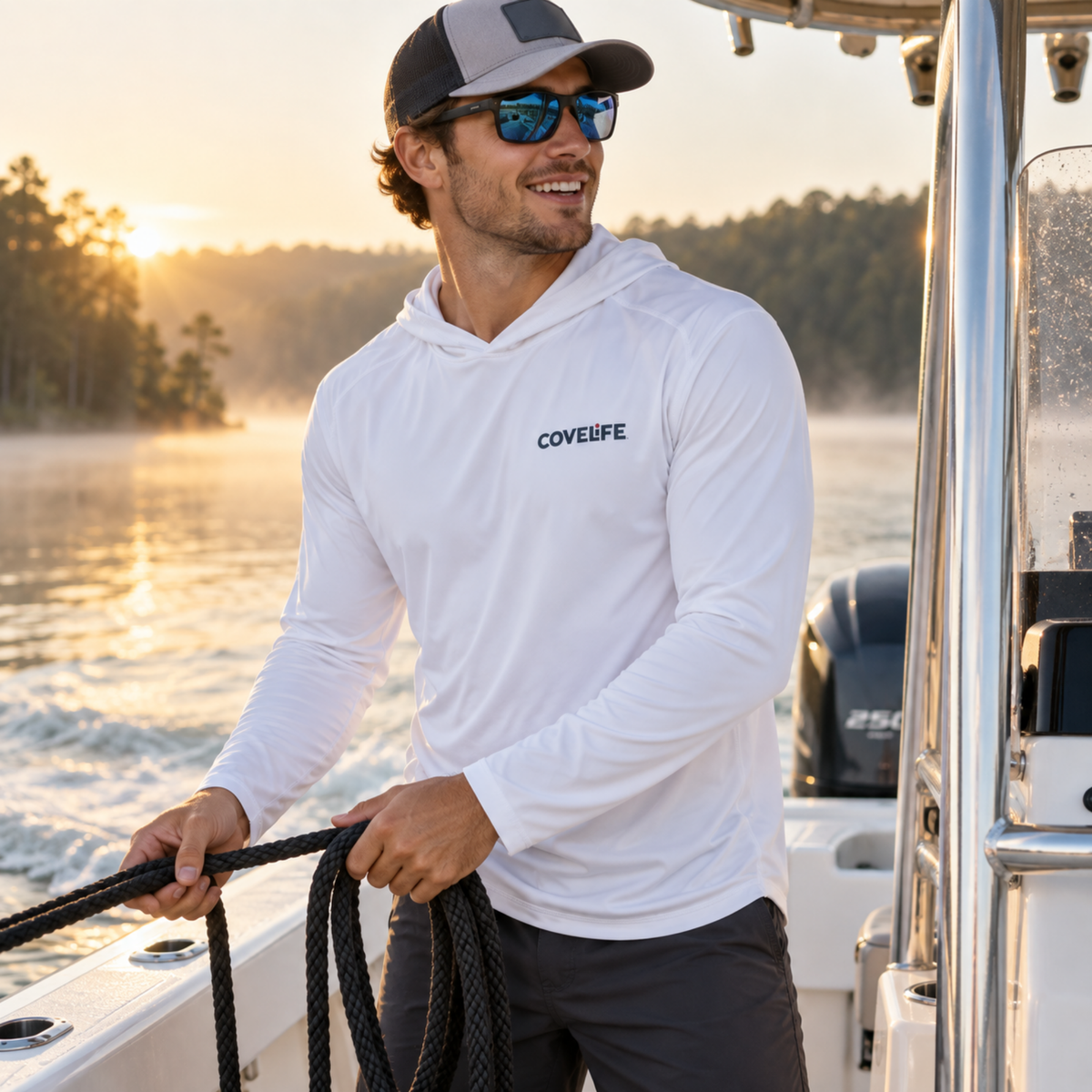 Man wearing the white COVELiFE SolarTech UPF 50+ Sun Hoodie while boating at sunset.