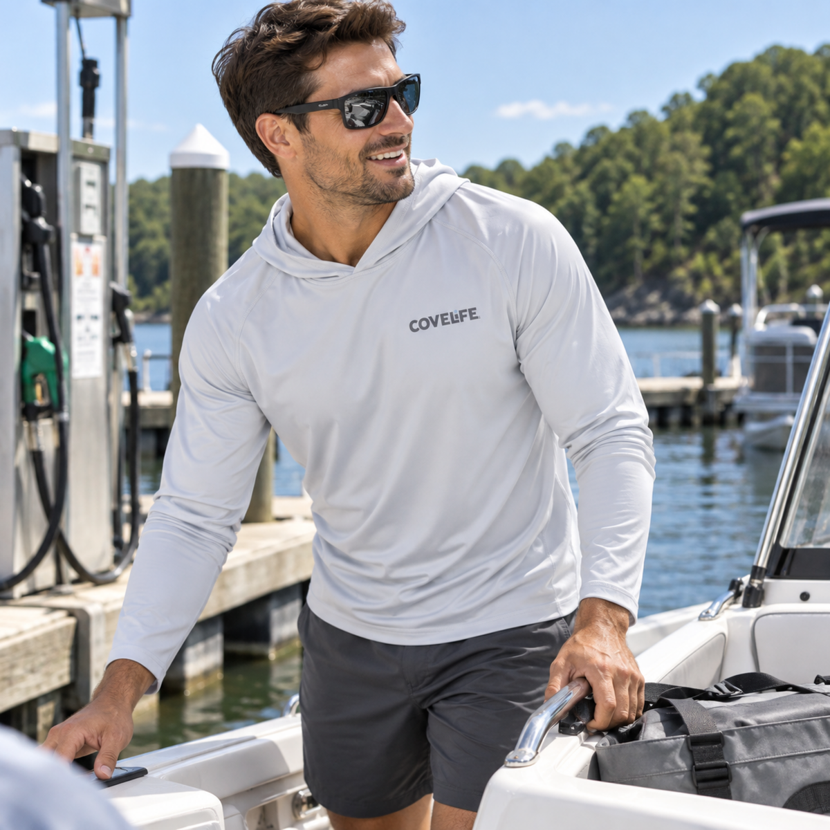 Man wearing the Pearl Grey COVELiFE SolarTech UPF 50+ Sun Hoodie on a boat.