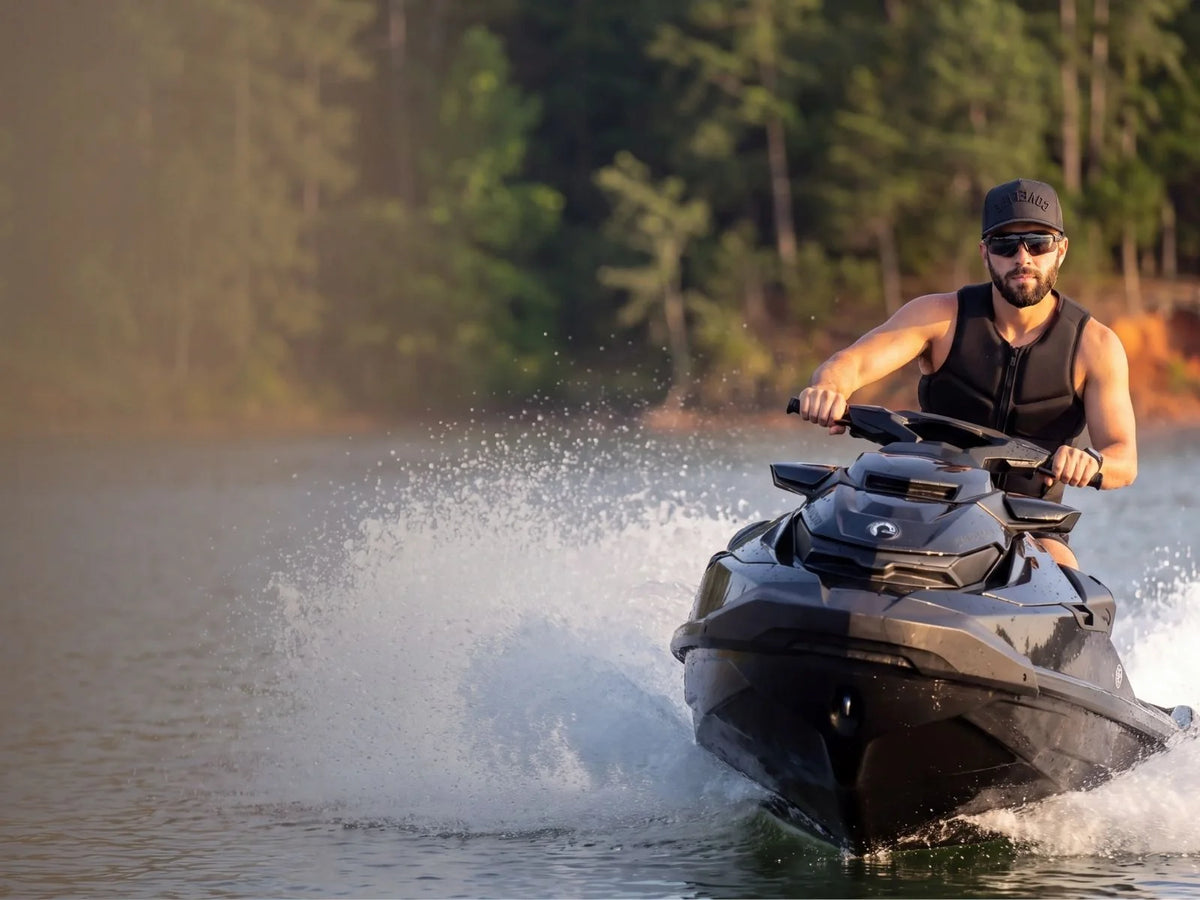 Man wearing a COVELiFE performance cap while riding a personal watercraft
